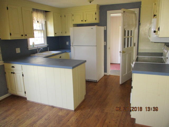 445 Nye Road Centerville, MA 02632 - Photo 2 of 7 a kitchen with wooden cabinets and a refrigerator