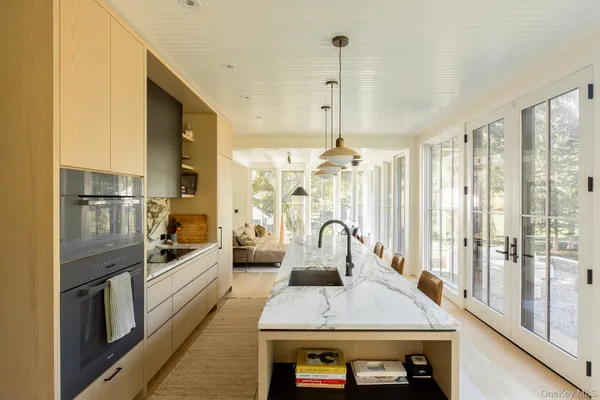 a kitchen with sink refrigerator and stove