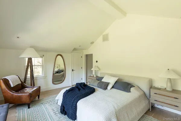 a bedroom with a bed a couch and dresser