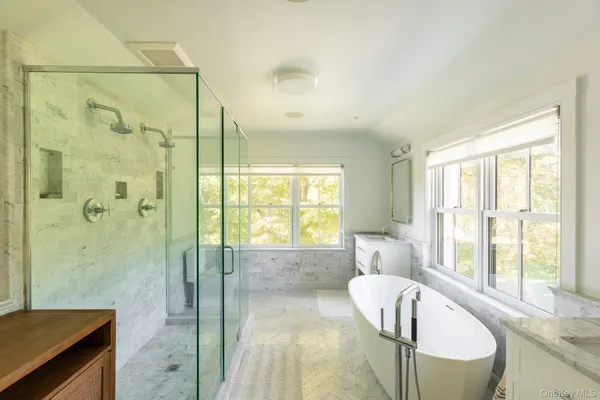 a spacious bathroom with a bathtub and a shower