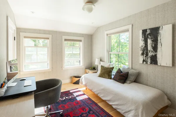 a bedroom with a bed and glass window