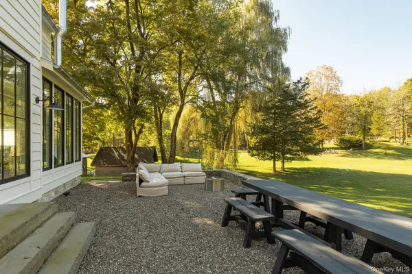 a view of a swimming pool with a patio and a yard
