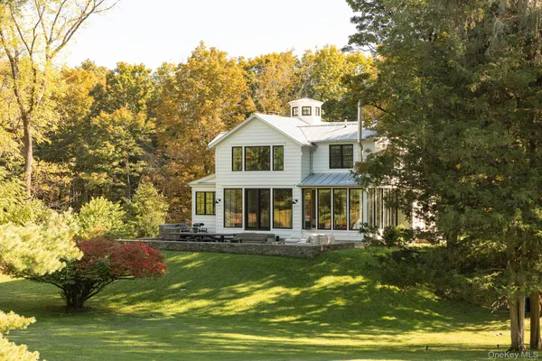 a front view of a house with a yard table and chairs