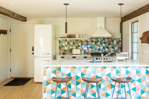 a living room with lots of furniture and a large window