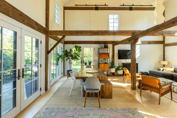 a living room with furniture a large window and a flat screen tv