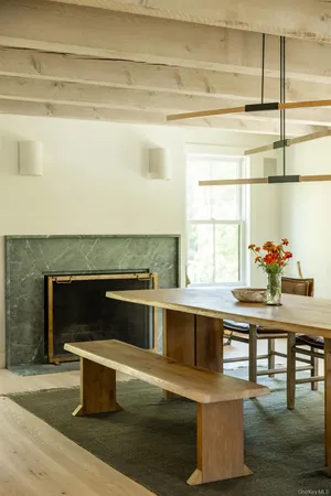 a living room with stainless steel appliances kitchen island granite countertop a sink and a granite counter tops