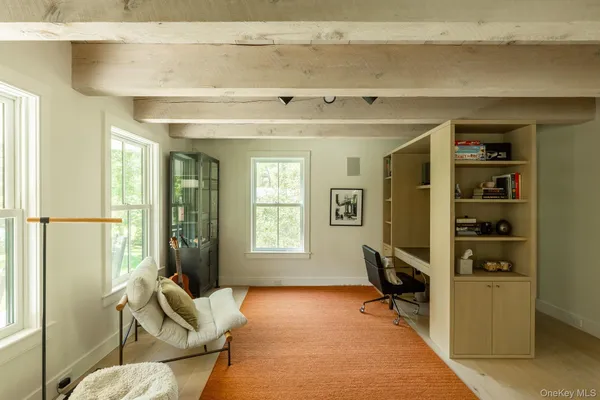 a livingroom with workspace and a window