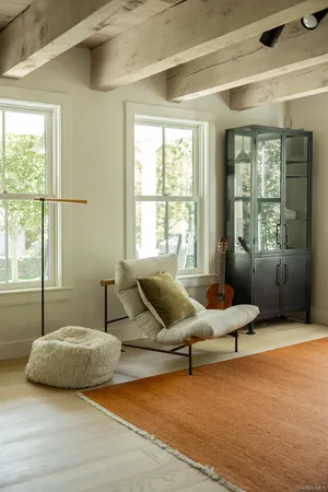a living room with furniture and floor to ceiling window