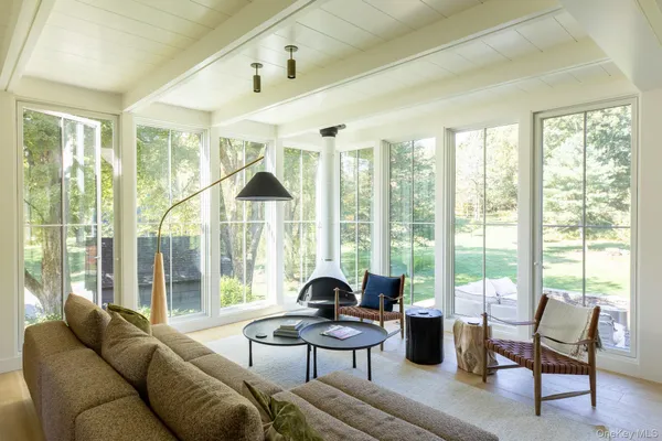 a living room filled with furniture and a large window