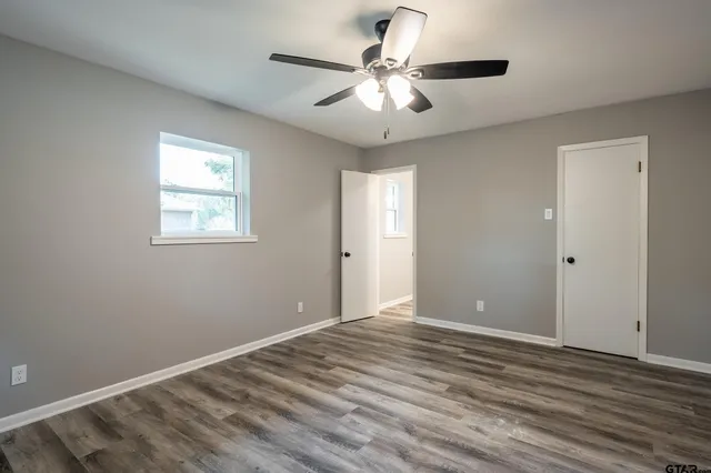 a view of room with window and ceiling fan