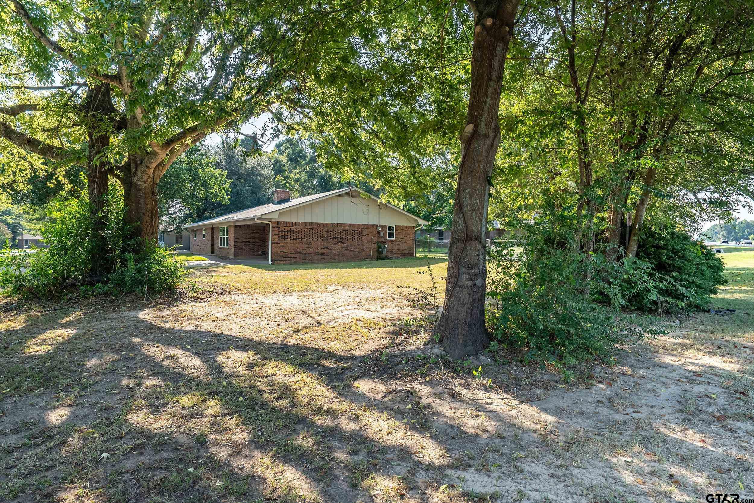 2201 King Road Jacksonville, TX 75766 - Photo 3 of 24 a house with trees in front of it