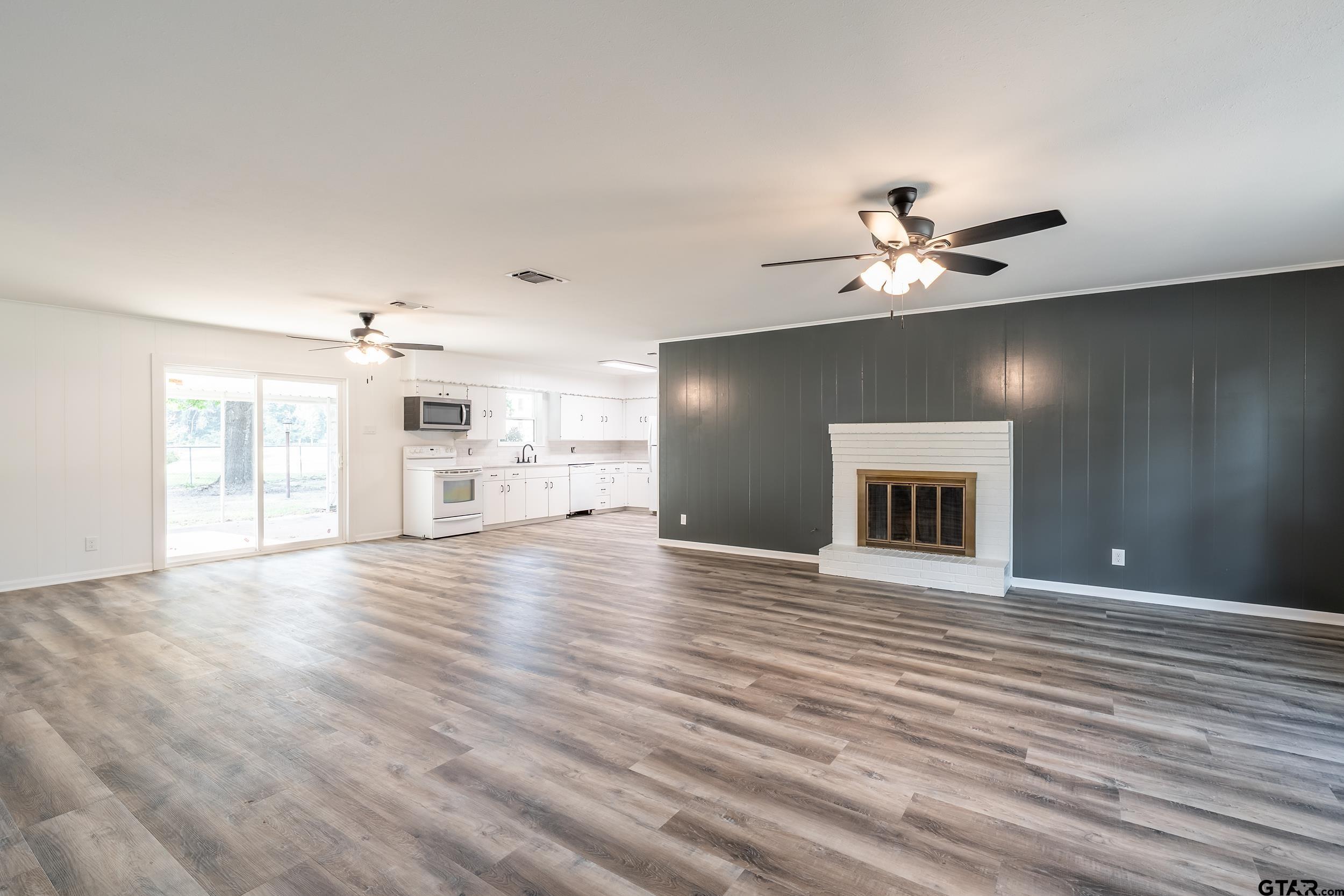 2201 King Road Jacksonville, TX 75766 - Photo 6 of 24 a view of an empty room with window and wooden floor