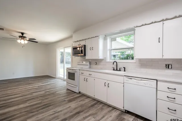 a kitchen with a sink cabinets and window