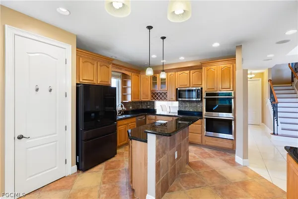 a bathroom with a granite countertop toilet a sink and shower