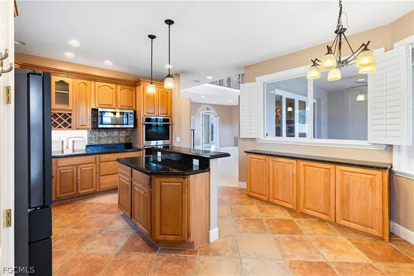 a view of a big room with a chandelier fan and closet area