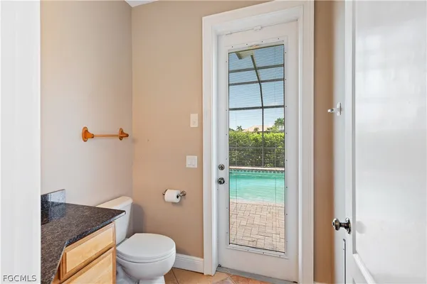 a bathroom with a granite countertop sink a mirror and a shower
