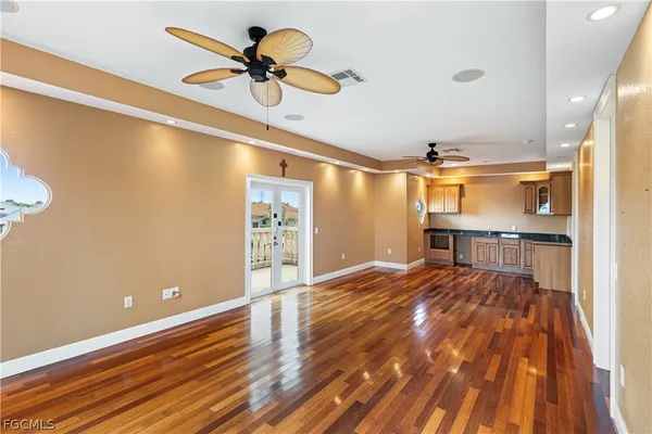 a view of a hallway with wooden floor and entryway