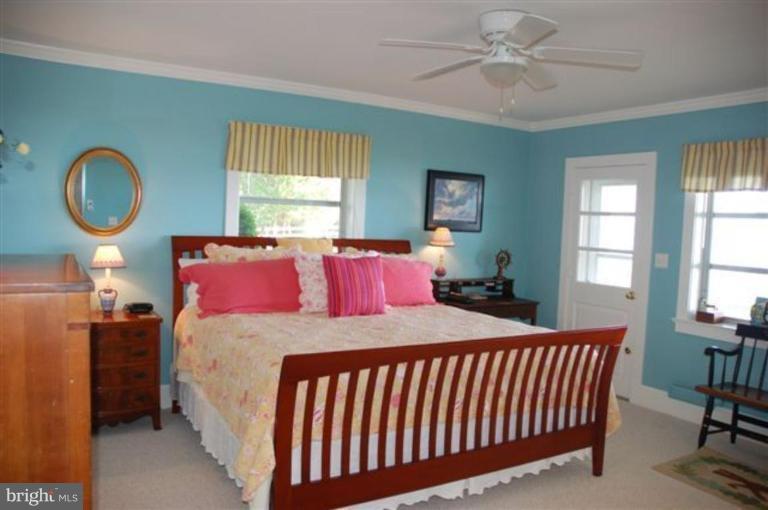 7188 Drum Point Road St. Michaels, MD 21663 - Photo 6 of 19 a bedroom with a bed mirror and window