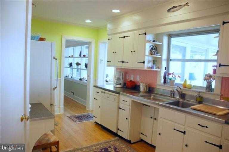 7188 Drum Point Road St. Michaels, MD 21663 - Photo 8 of 19 a kitchen with stainless steel appliances sink refrigerator and window