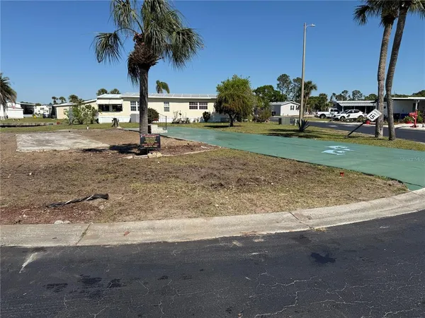 a view of a yard with cars