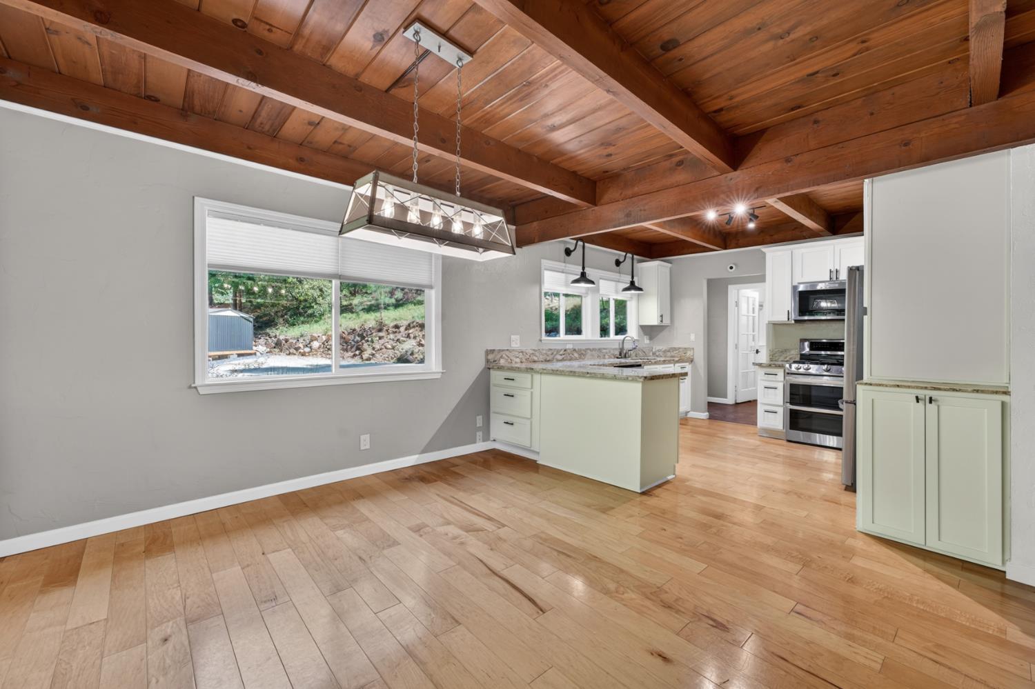 4340 Fairglade Road Placerville, CA 95667 - Photo 13 of 42 a room with a wooden floors and kitchen view