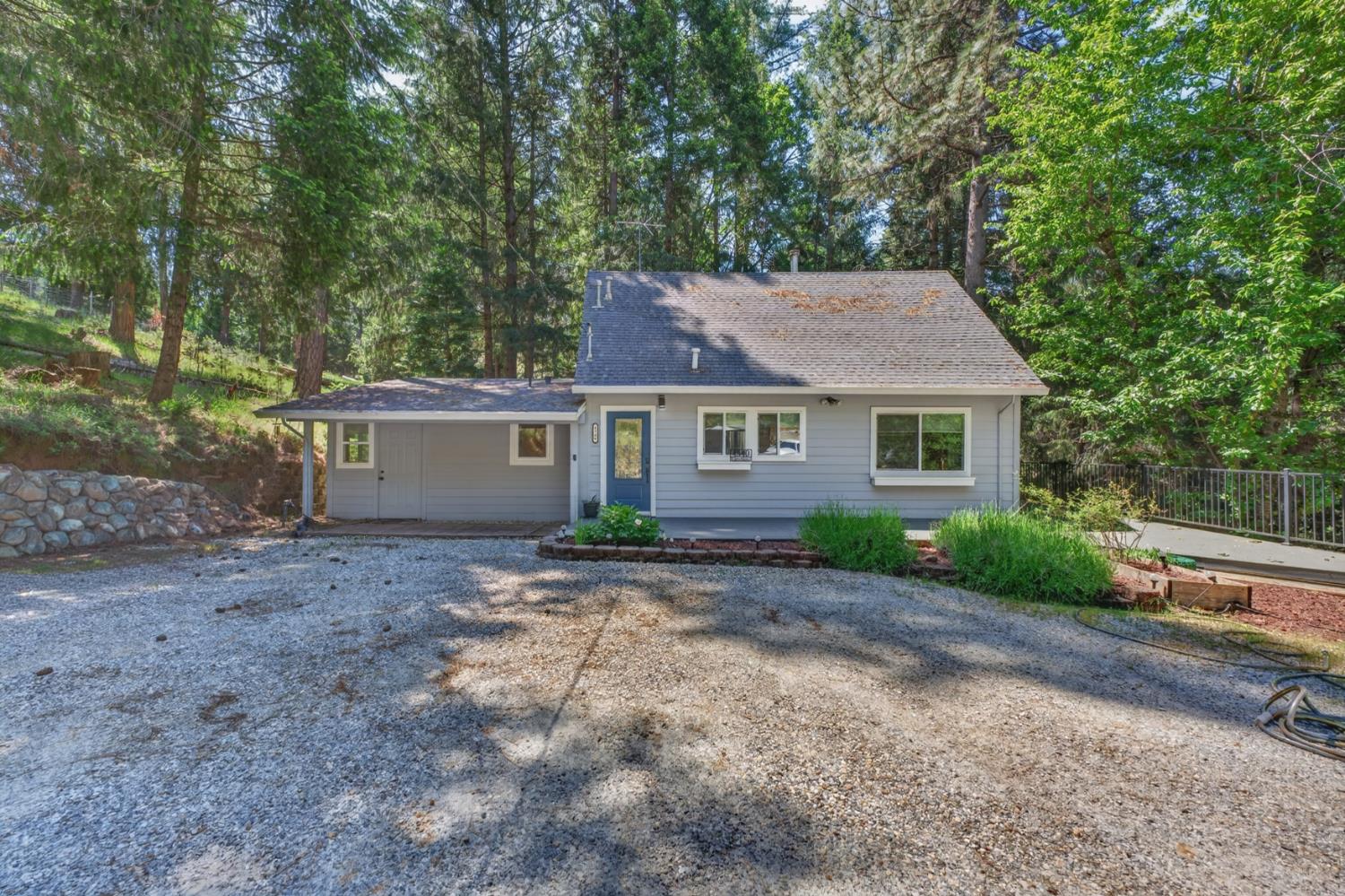 4340 Fairglade Road Placerville, CA 95667 - Photo 2 of 42 a front view of a house with a garden