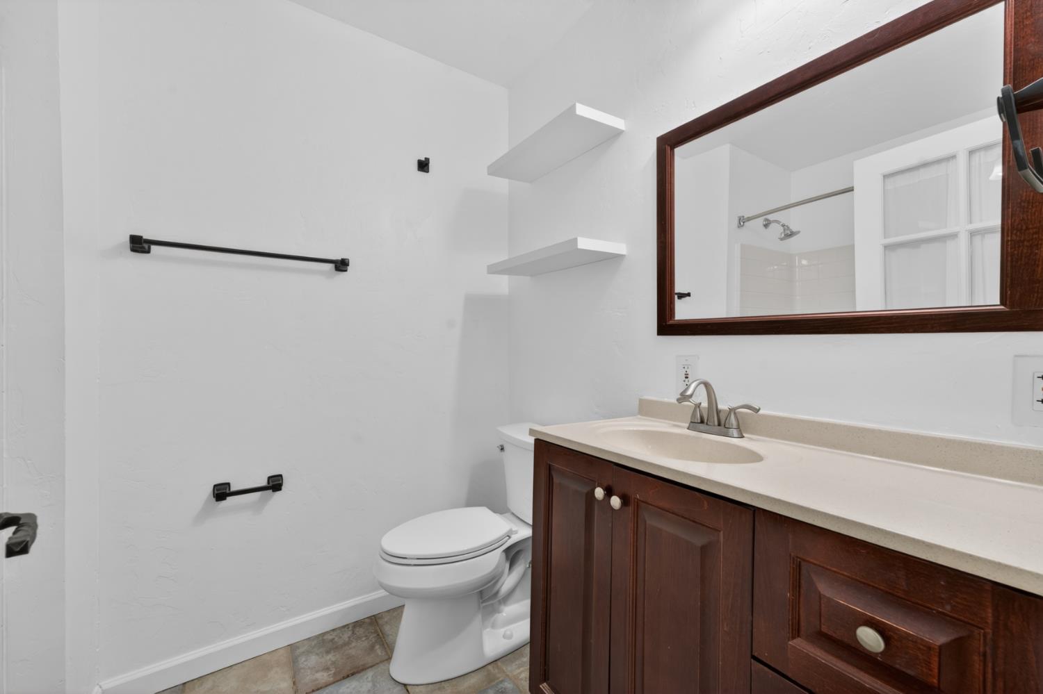 4340 Fairglade Road Placerville, CA 95667 - Photo 27 of 42 a bathroom with a sink a toilet and mirror