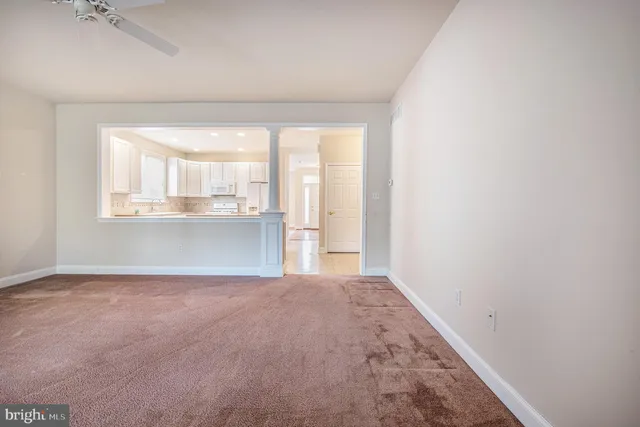 an empty room with a windows and a sink