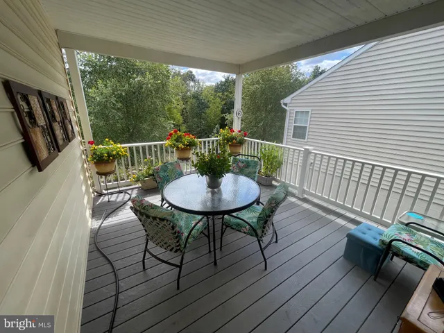 a view of a balcony with chairs and a table