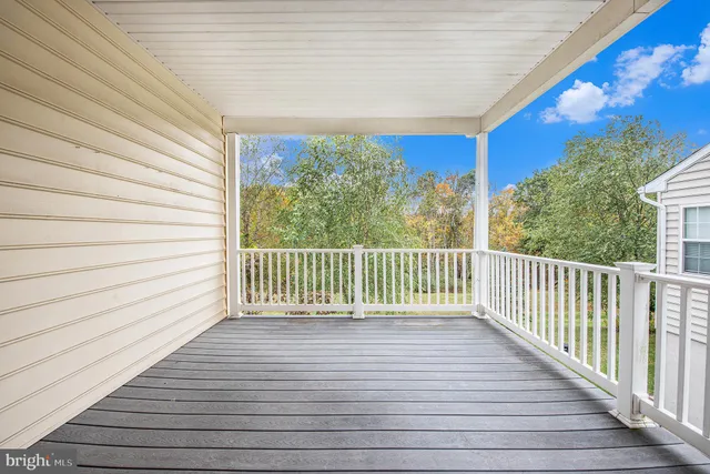 a view of a balcony with wooden floor