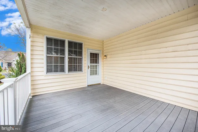 a view of a deck with wooden floor and fence
