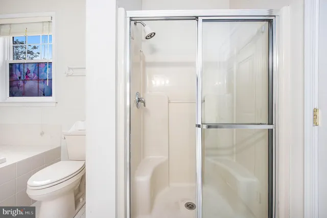 a bathroom with a glass shower door