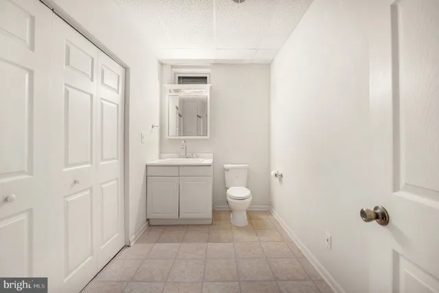 a bathroom with a toilet sink and a mirror