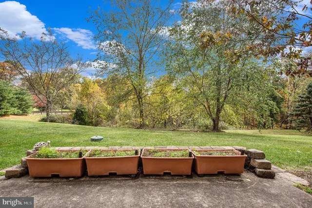 a backyard of a house with a yard and outdoor seating