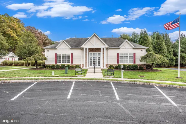 a view of a house with a large trees and a yard