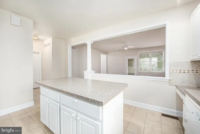 a view white cabinets and wooden floor