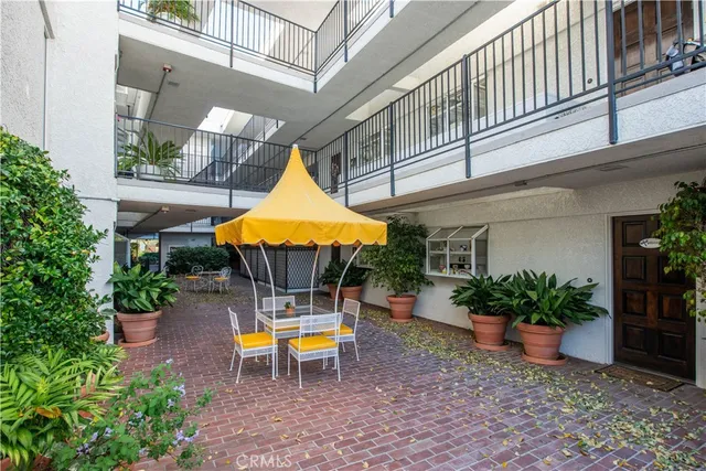 a backyard of a house with table and chairs