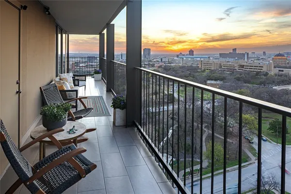 a view of a chairs and table in the balcony