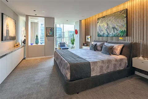 a spacious bedroom with a bed and a large window