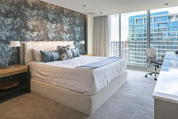 a bed sitting in a bedroom next to a window