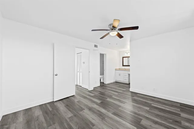 a view of empty room with wooden floor