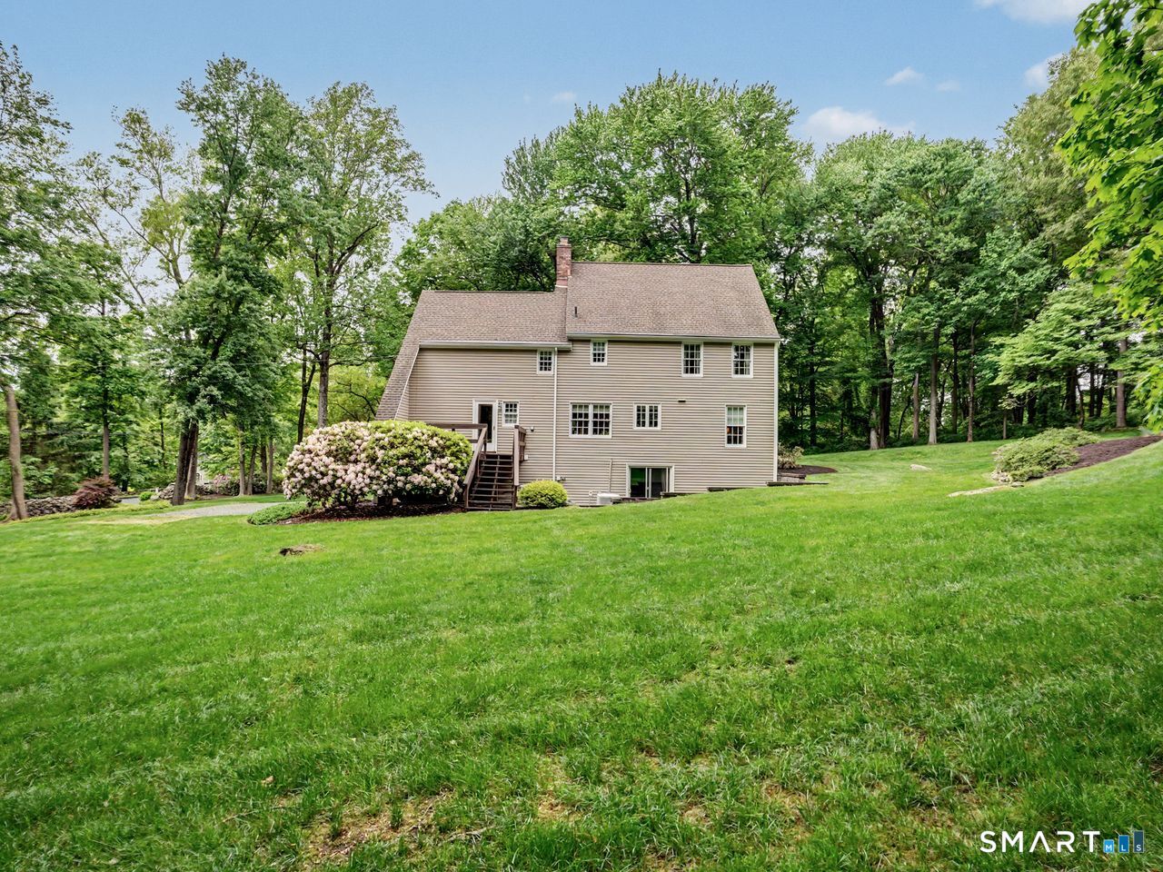 86 Fire Hill Road Redding, CT 06896 - Photo 30 of 36 a view of a backyard with large trees and barn in it