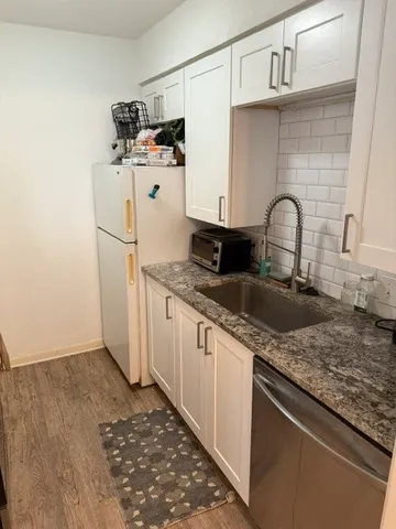 a kitchen with stainless steel appliances granite countertop a sink and cabinets