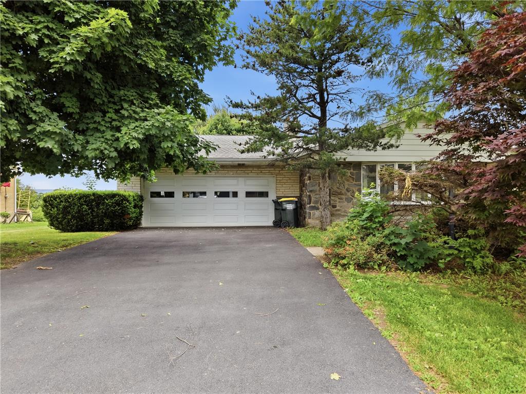 1657 Clearview Road Coplay, PA 18037 - Photo 8 of 77 A classic front facade with a two-car garage, mature trees, and a paved driveway.
