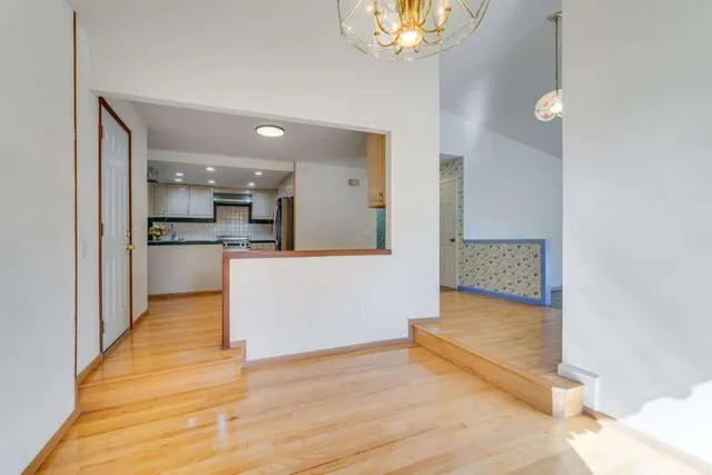 a view of kitchen with cabinets and wooden floor