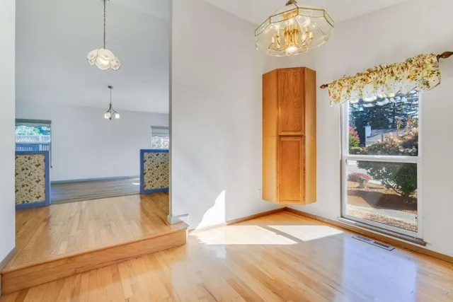 a view of a room with wooden floor and window