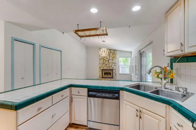 a kitchen with granite countertop a sink and cabinets