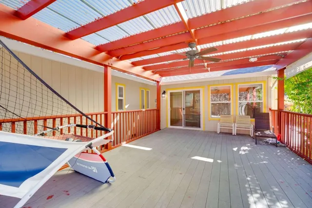 a view of an empty room with wooden floor and stairs