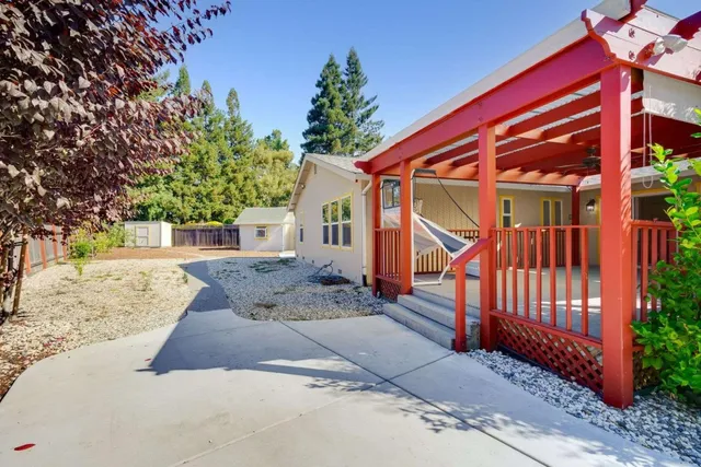 a view of a house with a yard and tree s