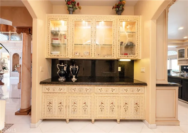a large kitchen with stainless steel appliances granite countertop a sink and cabinets